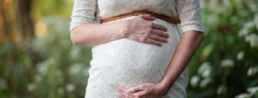 pregnant woman holding bump